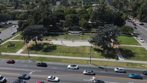 Los Angeles , CA , United States - 01 08 2022: Aerial View of Beverly Hills Sign, Pond, Green Garden and People on a Sunny Day. Drone Shot