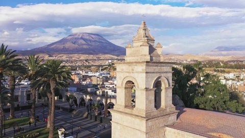 Arequipa cathedral bell tower and volcano back and forth Drone