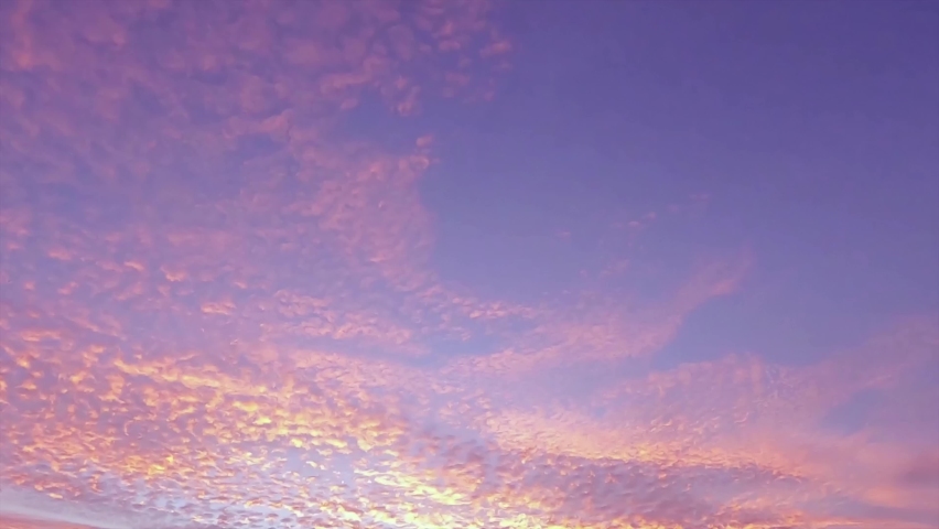 Colorful sunrise or twilight sunset on beautiful pastel blue sky with golden pink cloud n orange cirrocumulus cloudscape in tropical summer sunlight n sun ray at dusk or dawn view, 4k b-roll TimeLapse Royalty-Free Stock Footage #1085434130