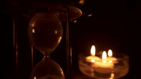 hourglass and floating candles as time lapse