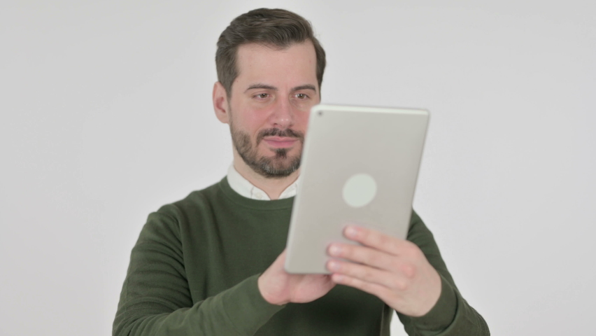 Portrait of Man Celebrating on Tablet in Office, White Screen