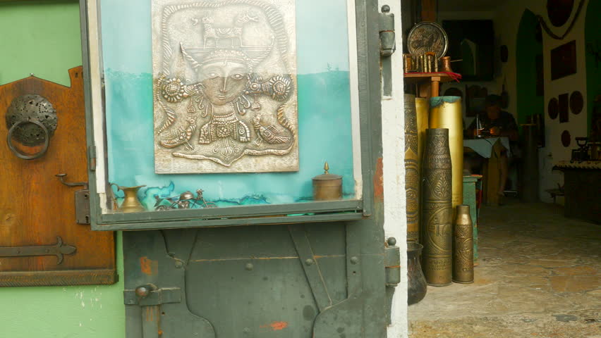 Workshop in Mostar showing coppersmith making tourist gifts out of old war shell casings.