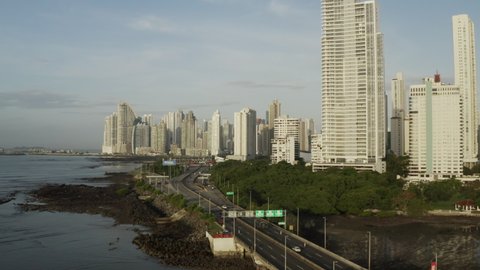 aerial view of tall buildings in Panama City near the Pacific Ocean, slide close up