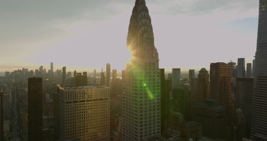Ascending footage of iconic Chrysler Building with spire of top. Aerial footage against setting sun. Manhattan, New York City, USA Royalty-Free Stock Footage #1085450237