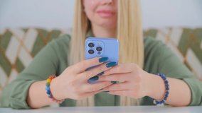 White woman typing message on mobile phone. Young adult Caucasian female using smartphone with triple camera. Person communicating online with modern cellphone in closeup stock video