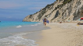 woman running with greece flag by egremni beach lefkada island - Powered by Shutterstock - Get 15% off with code: PIKWIZARD15