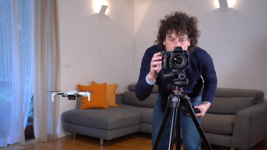 A photographer uses a drone for surveying, photography and video of apartment and building interiors - real estate and home staging for sell the home - new 4k aerial technology Royalty-Free Stock Footage #1085454242