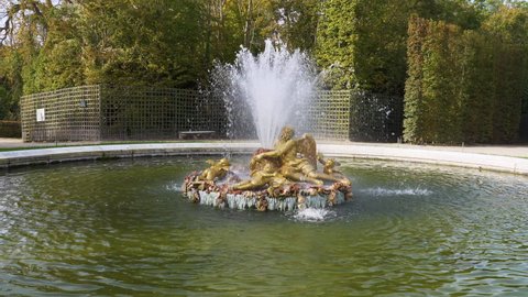 Versailles, France - October 17, 2021: Saturn Fountain (or Winter fountain) in the Gardens of famous Chateau de Versailles.