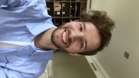 Vlogging, videocall event, modern tech, distance talk concept. Vertical webcam close up view millennial bearded guy sit on couch at home holds device record new videovlog, make speech in front of cam - Powered by Shutterstock - Get 15% off with code: PIKWIZARD15