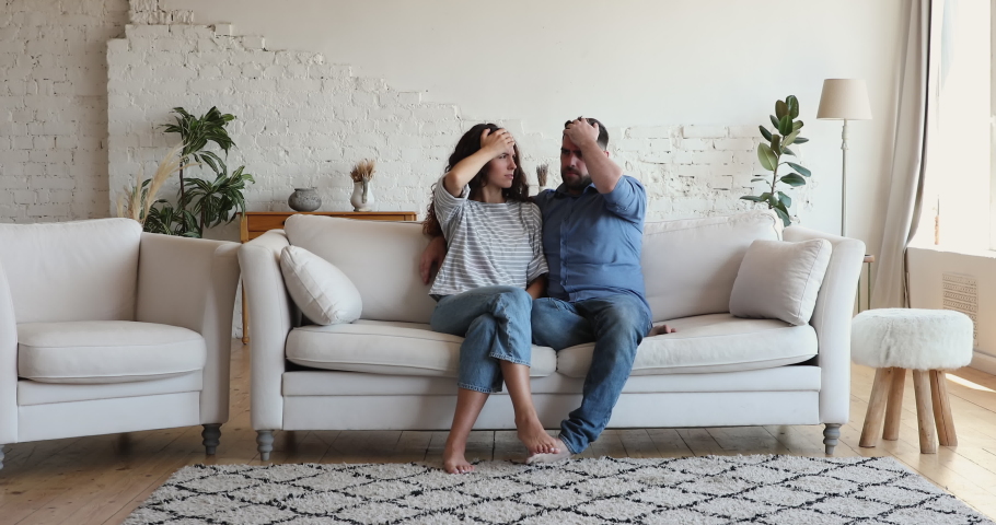 Restless kids running around of annoyed parents sit on couch feel irritated due noisy active children, spend quarantine at home looking exhausted. Upbringing difficulties, misbehaved offspring concept Royalty-Free Stock Footage #1085456714