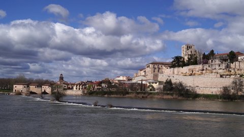 Cathedral of Zamora (Spain) and the old town on the banks of the Duero with the river mills and their dam in the foreground
