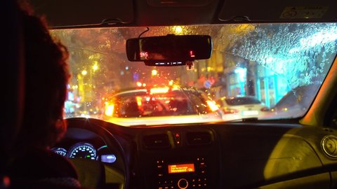 Istanbul,Turkey- 02.25.2021:View inside a taxi in traffic on a rainy day. The wipers of the car are working.