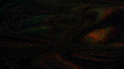 Moving background consisting of red-green-yellow particles flowing on a black background.