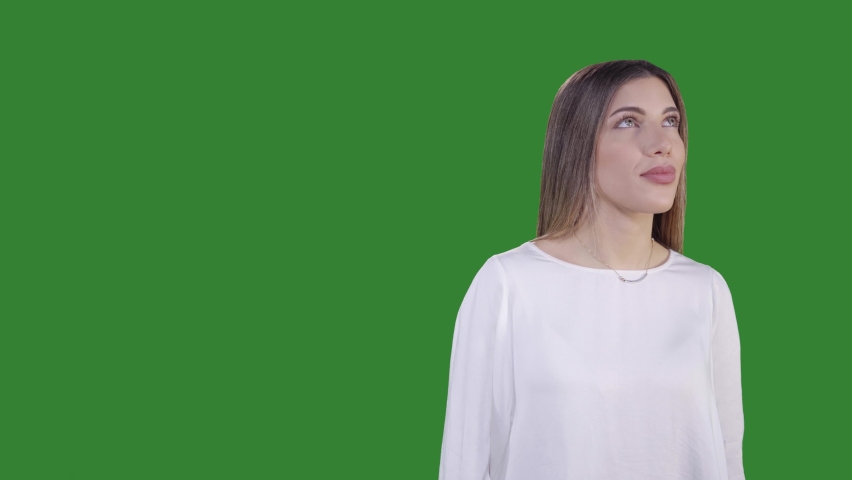 Young women looking around and pointing her hand to the left on green screen Royalty-Free Stock Footage #1085471624