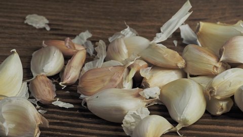 Garlic cloves isolated on wooden background.