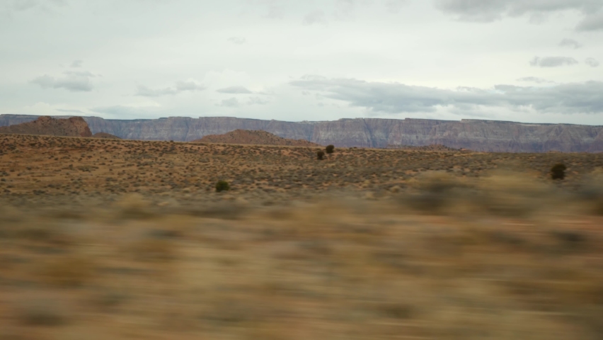 Road trip to Grand Canyon, Arizona USA, driving auto from Utah. Route 89. Hitchhiking traveling in America, local journey, wild west calm atmosphere of indian lands. Colorado plateau from car window.