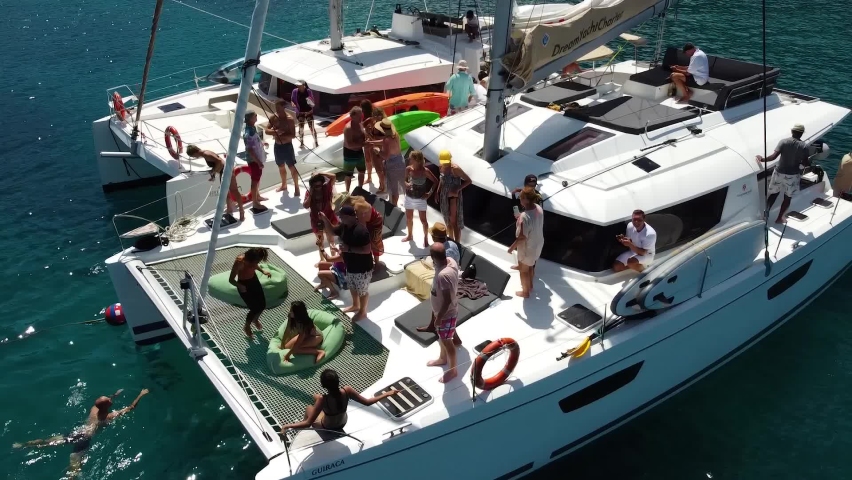 Phuket, Thailand, 19, December, 2019:
Party on sailing yachts, many people have fun on the bow of Dream Yacht sailing catamarans