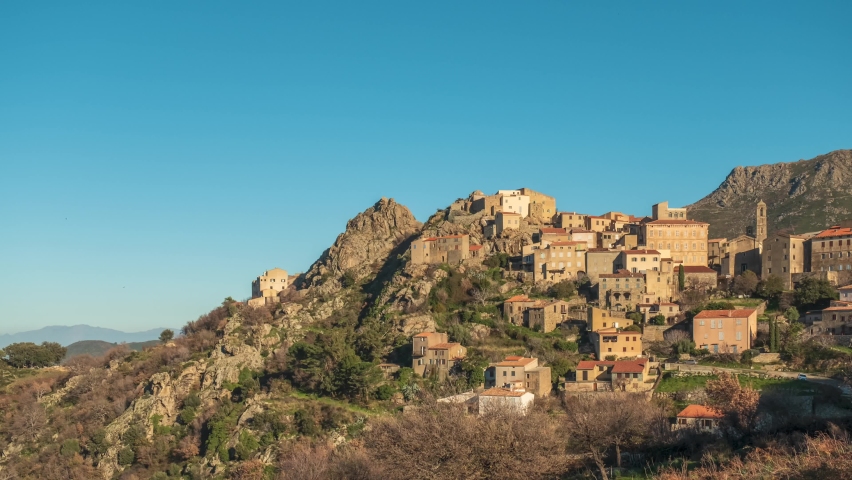 Time lapse of sun setting and moon rising over the ancient mountain village of Speloncato in the Balagne region of Corsica Royalty-Free Stock Footage #1085484614