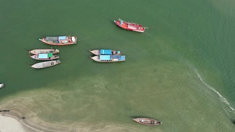 4K over Pier in Laem Son National park with local fishing boats from aerial view by drone. Laem Son National park is locate in Kapur District, Ranong, Thailand 