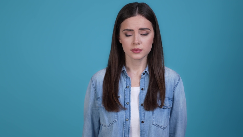 Nervous upset lady look up pray isolated blue color background | Shutterstock HD Video #1085491418