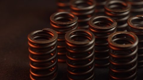 closeup of engine head spring, red reflections, for perfomance and tuning motor