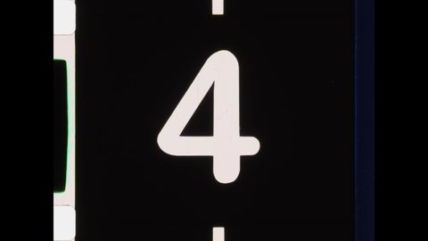 Countdown Leader, Picture Start. 4K Overscan of 16mm Film Showing Frame Lines. Black and White Countdown from 8 to 2. Abstract Handwriting on Film of Letters and Symbols. Scratches on the Emulsion 