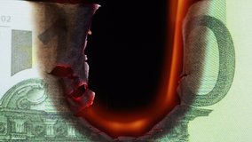 Burning of 100 euro banknote on black bacground close-up. Flame of fire from cash. Financial crisis and depressed economy. Paper money loss concept. - Powered by Shutterstock - Get 15% off with code: PIKWIZARD15