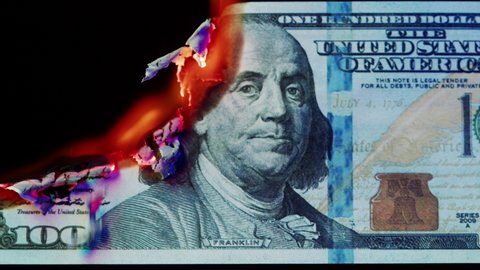 Burning American hundred dollar banknote on black background. Flame of fire from cash close-up. Financial crisis and depressed economy. Paper money loss concept. 