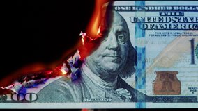 Burning American hundred dollar banknote on black background. Flame of fire from cash close-up. Financial crisis and depressed economy. Paper money loss concept.  - Powered by Shutterstock - Get 15% off with code: PIKWIZARD15
