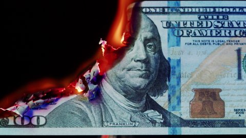 Burning American hundred dollar banknote on black background. Flame of fire from cash close-up. Financial crisis and depressed economy. Paper money loss concept. 