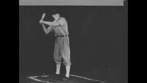 1940s: Baseball player at bat, holds bat in bunting position. Side view, player holds bat in bunting position. Player holding bat by arrow.