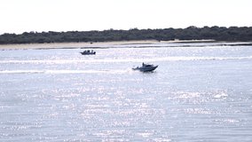 Motor speed boat navigating the bay of El Portil beach in Punta Umbría, Huelva. Video in Slow motion