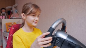 Girl learning to drive a wheel simulator indoors