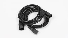 Two black power cord C13-C14 connector, on white. Side view. Loop motion. Rotation 360. 4K UHD video footage 3840X2160.