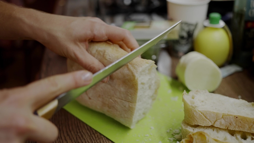 Woman trying to cut bread with a dull knife, blunt blade