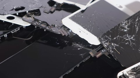 Prague, CZ - 16 January 2022: A heap with the Apple iPhone broken screens lying one on top of another. Close-up Devices are prepared for utilization. Editorial