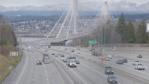 Surrey Central, Greater Vancouver, British Columbia, Canada - December 15, 2021: Traffic Driving on Trans-Canada Highway across Port Mann Bridge.