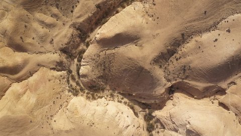Bird's eye perspective of dry river meandering through beautiful desert landscape in the Negev in Israel. Climate change concept. 