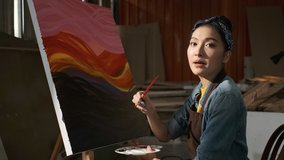 Asian Female Artist Draws create art piece Make an online tutor with palette and brush painting at studio.