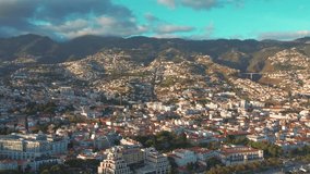 Aerial 4K footage of a drone flight over Funchal coastline in Madeira island in the evening