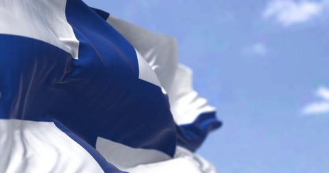 Detail of the national flag of Finland waving in the wind on a clear day. Democracy and politics. North European country. Selective focus. Seamless Slow motion