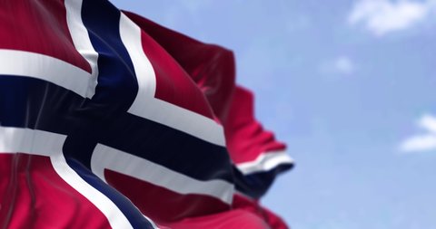 Detail of the national flag of Norway waving in the wind on a clear day. Democracy and politics. North European country. Selective focus. Seamless Slow motion