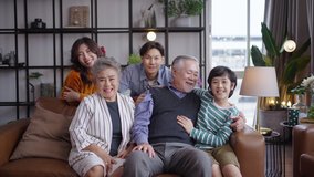 Portrait of happy Asian family spending time together on sofa in living room. family and home concept. - Powered by Shutterstock - Get 15% off with code: PIKWIZARD15