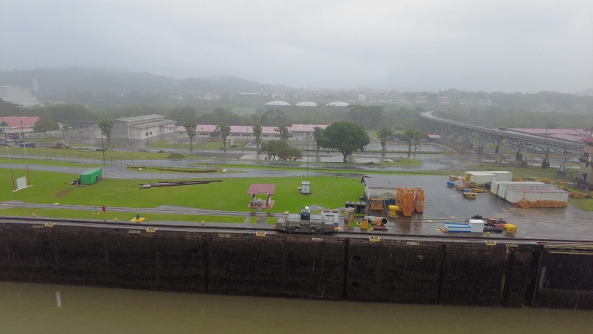 Mule locomotive prepare to navigate ship on Miraflores Locks at Panama Canal