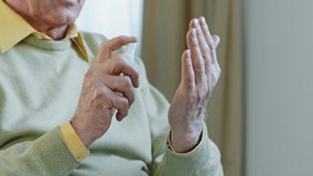 Close-up hands elderly man unrecognizable pensioner cleaning arms by sanitizer antiseptic spray hygiene product coronavirus protection spraying antibacterial remedy prevention epidemic covid19 concept - Powered by Shutterstock - Get 15% off with code: PIKWIZARD15