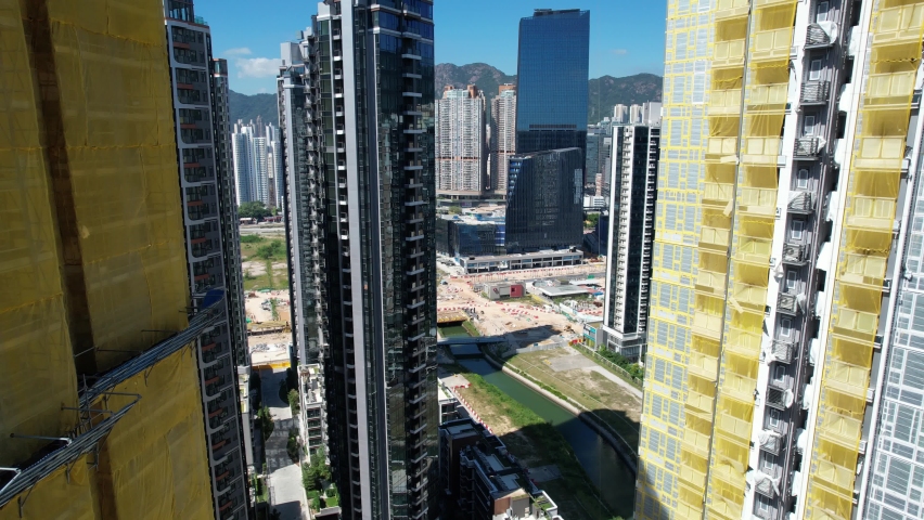 Commercial residential construction site in Kai Tak Hong Kong city, Kwun Tong and Kowloon Bay near Victoria harbor, Aerial drone | Shutterstock HD Video #1085527079