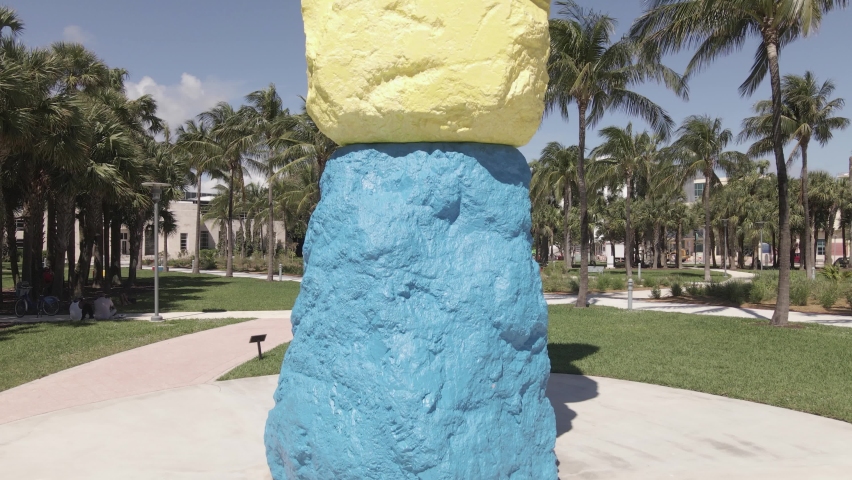 Rising aerial reveals five stacked colored rocks called Miami Mountain