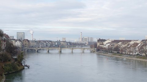 Basel , Switzerland - 12 12 2021: Basel, Switzerland December 2021: Cloudy sky above the Rhine river in Basel with view of the main historic bridge and the skyline of the city