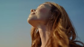 Closeup woman with camera enjoying sunlight in beautiful garden with wildflowers. Close up young woman photographer staying in tulip field in sunny day. Beautiful lady wih photocamera having rest.  - Powered by Shutterstock - Get 15% off with code: PIKWIZARD15