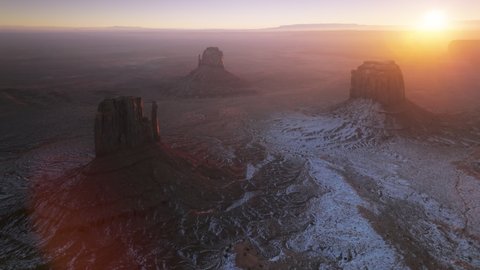 Breathtaking sunrise shining above Monument valley nature park, Navajo Tribal Arizona USA. Aerial drone view of famous landmark from western movies, Hollywood filming location at winter 4K footage
